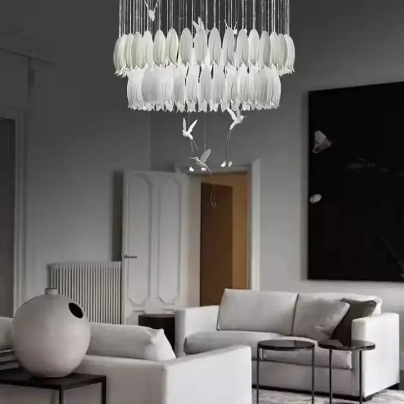 Modern living room with a stylish chandelier and white furniture.