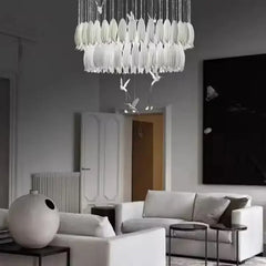 Modern living room with a stylish chandelier and white furniture.