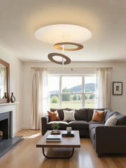 Modern living room with a sectional sofa, coffee table, and ceiling light fixture.