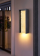 Modern outdoor wall light fixture on a building exterior.