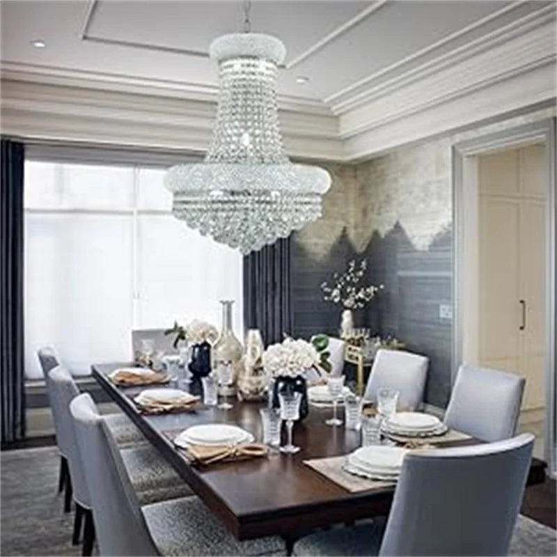 Elegant dining room with a chandelier, table set for dinner, and decorative elements.