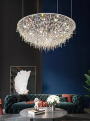 Luxurious living room with a crystal chandelier, green sofa, and decorative elements.