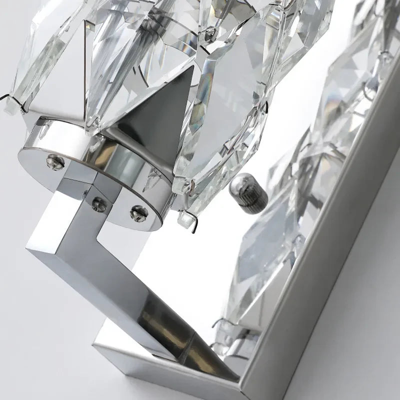 Close-up of a crystal chandelier with clear and silver details on a white background