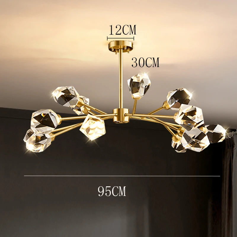 Gold chandelier with crystal-like fixtures on a dark background, showing measurements.