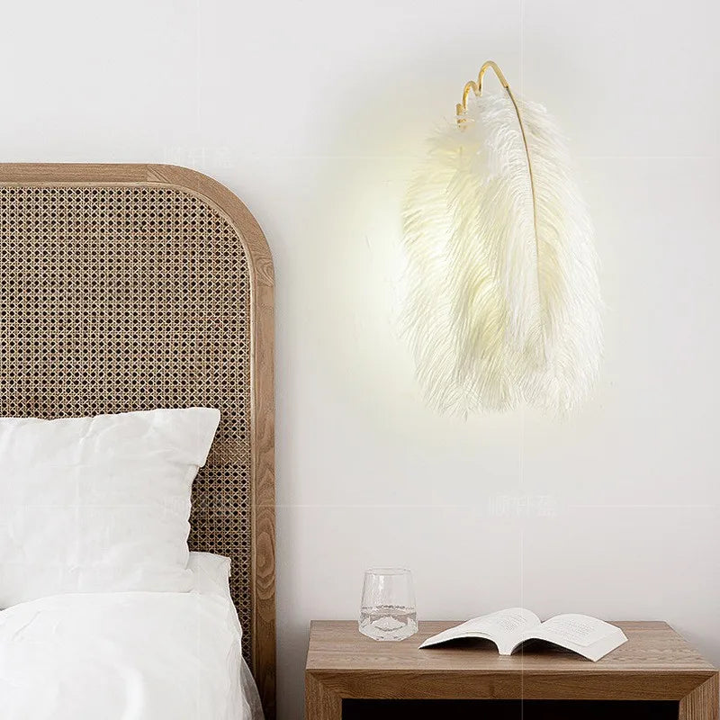 Bedroom with wicker headboard, nightstand, and feather wall light fixture.