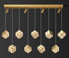 Gold ceiling light fixture with hanging crystal-like cubes on a black background