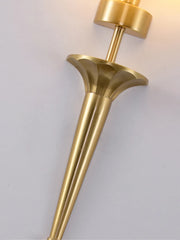Gold wall sconce on a light gray background