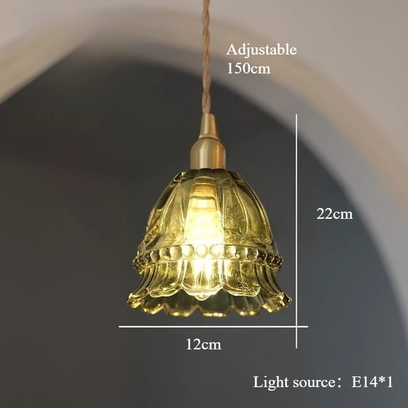 Pendant light with decorative glass shade and measurements on a plain background