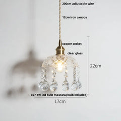 Pendant light with clear glass shade and measurements on a white background