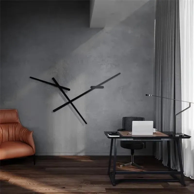 Black geometric line wall sconce mounted on a gray wall in a home office setting, with a desk and chair nearby.