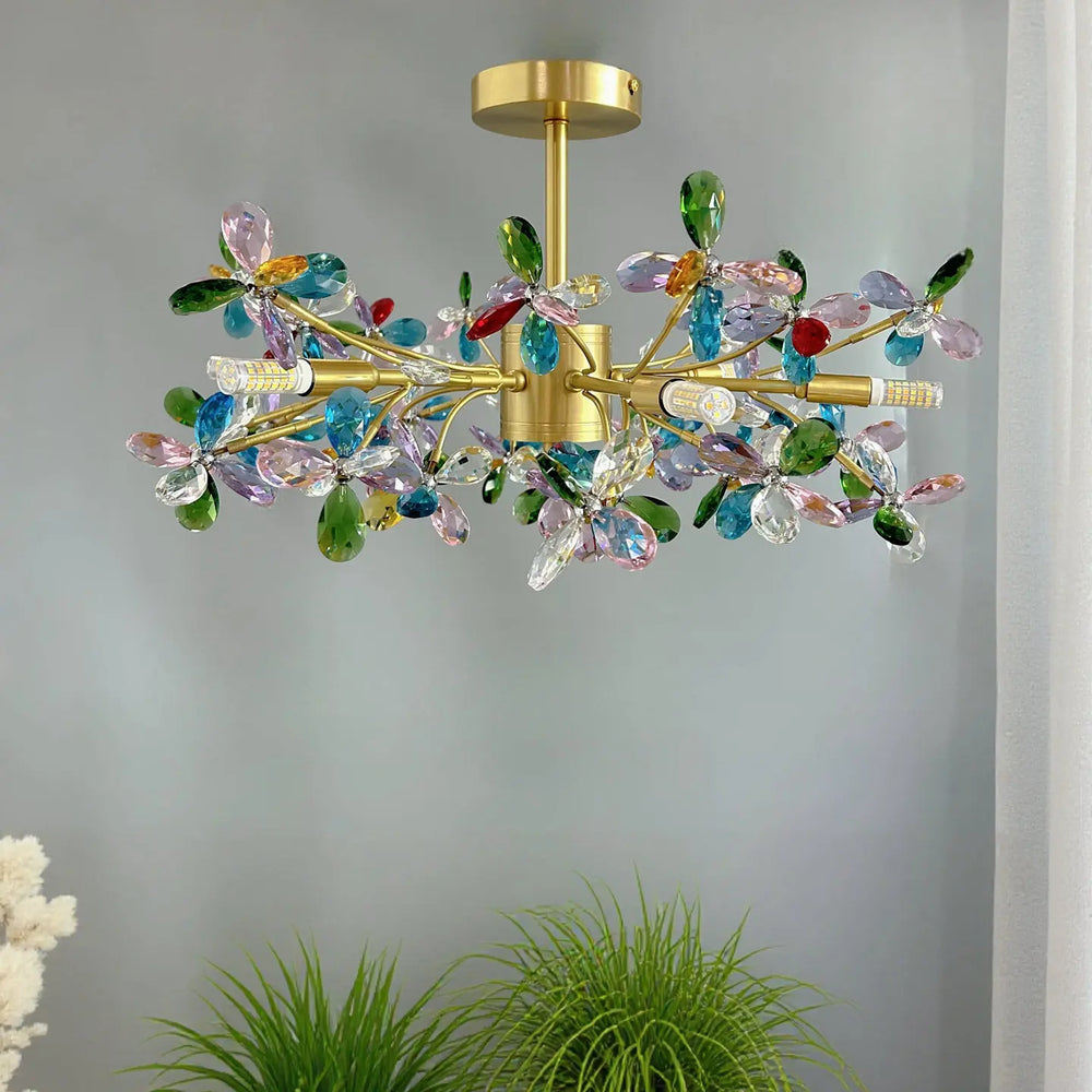 Close-up view of the multi-colored crystal flower details and gold frame of the chandelier.