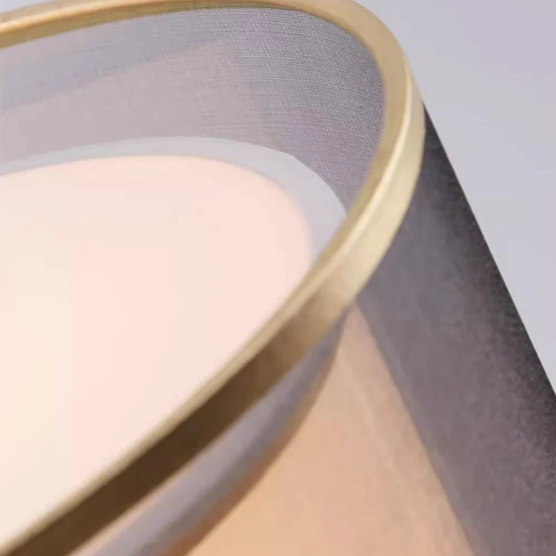 Close-up of a pink makeup compact with a gold lid on a gray background