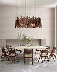 Modern dining room with a wooden pendant light, round table, and chairs.