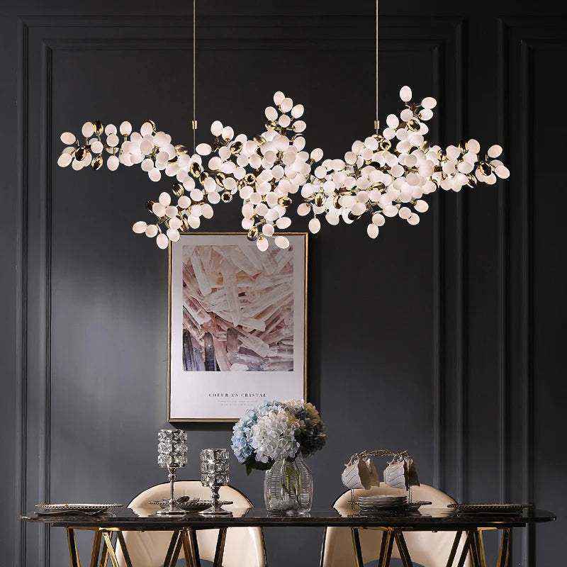 A close-up of the gold grapes bunch chandelier, showing the details of the individual bulbs and metallic structure.