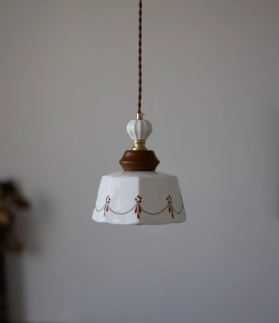 Pendant light with decorative design on a plain background