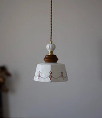 Pendant light with decorative design on a plain background