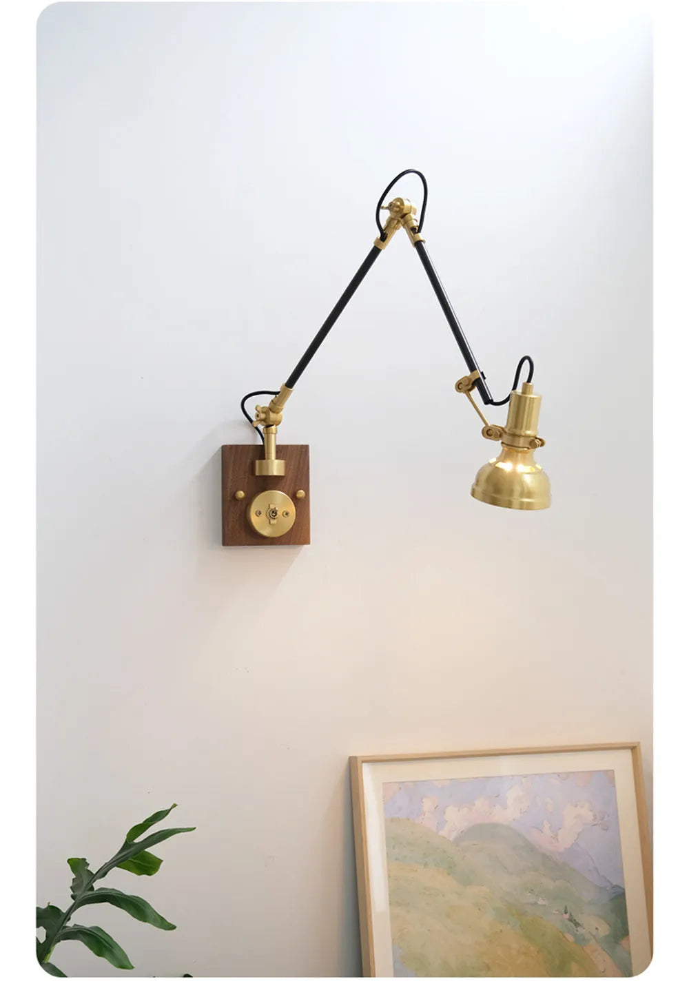 Angle view of the brass adjustable swing arm wall sconce, showing the wooden backplate and knob switch.