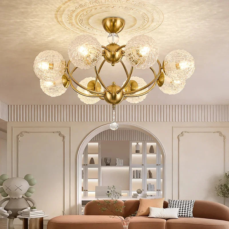 View of the gold semi-flush ceiling light installed in a bedroom setting above a bed.