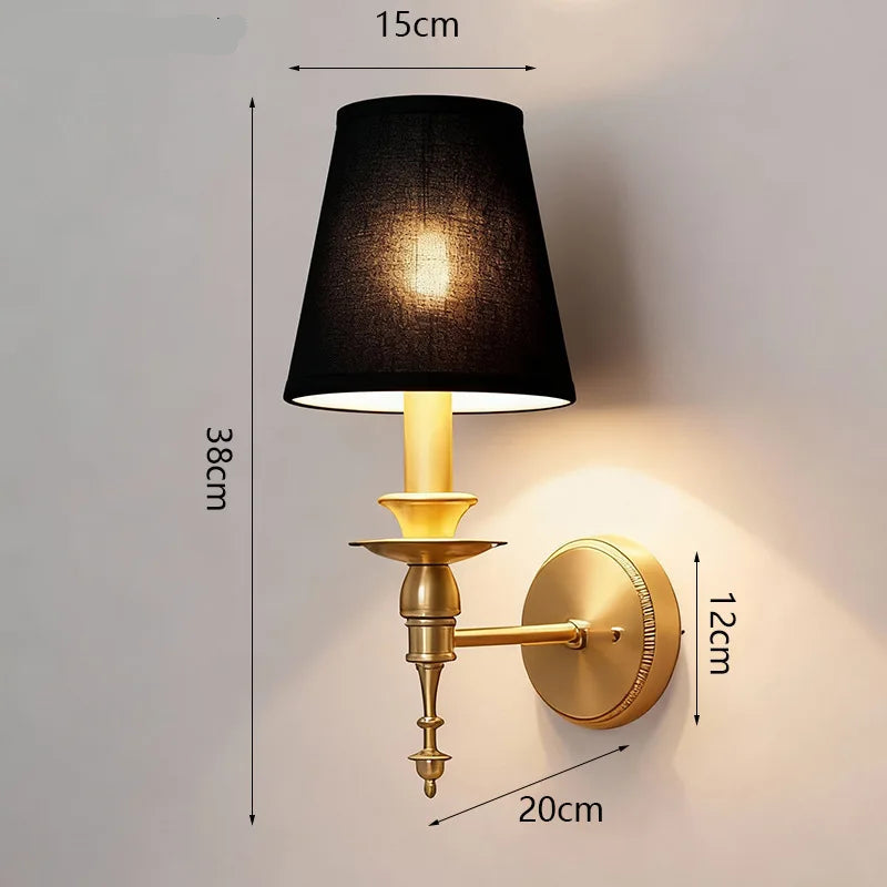 Wall-mounted lamp with black shade and gold base, showing dimensions on a gray background
