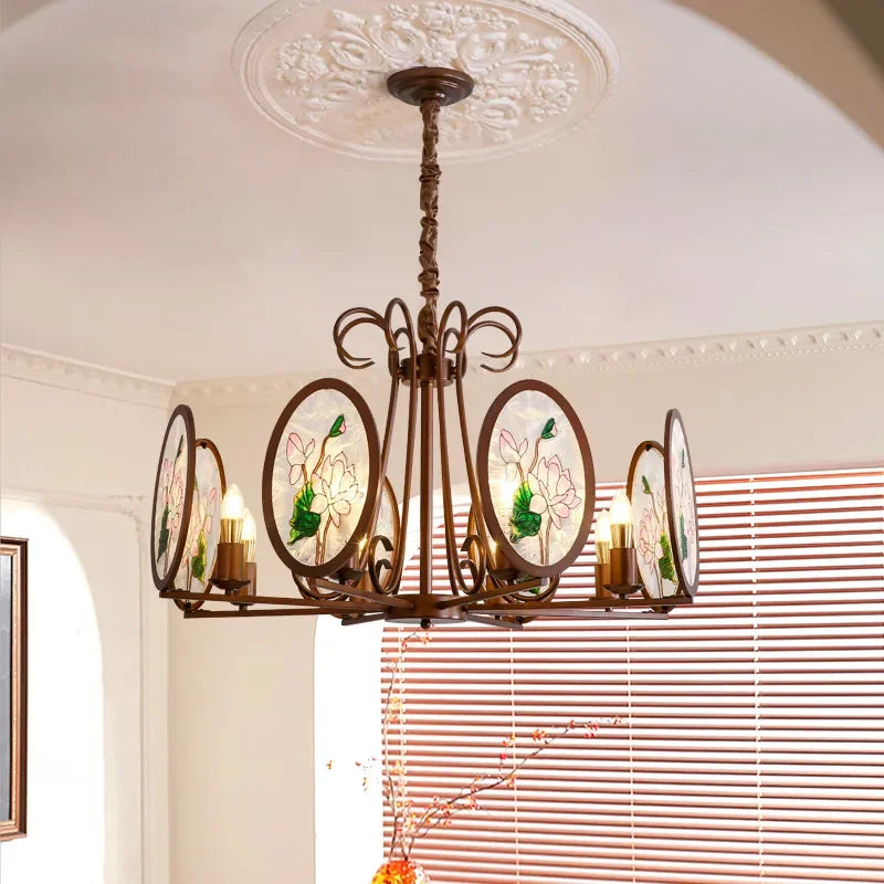 A matte bronze chandelier with oval glass panels featuring a pink and green floral design.