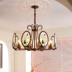 A matte bronze chandelier with oval glass panels featuring a pink and green floral design.