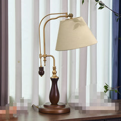 Decorative table lamp with beige shade and wooden base on a surface.
