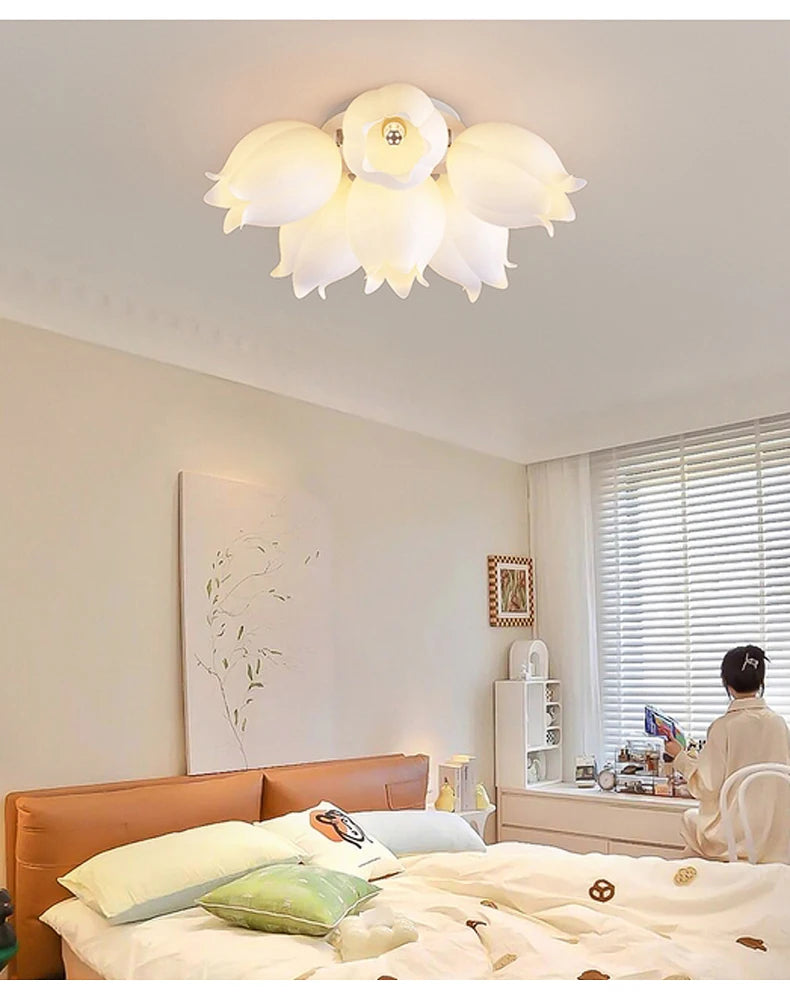 White orchid blossom flush mount ceiling light above a bed in a bedroom