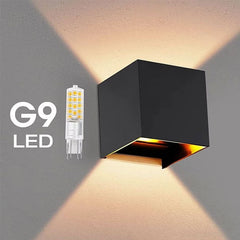 Black square wall light fixture with G9 LED bulb on a gray background