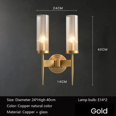 Gold wall sconce with dimensions and material details on a dark background