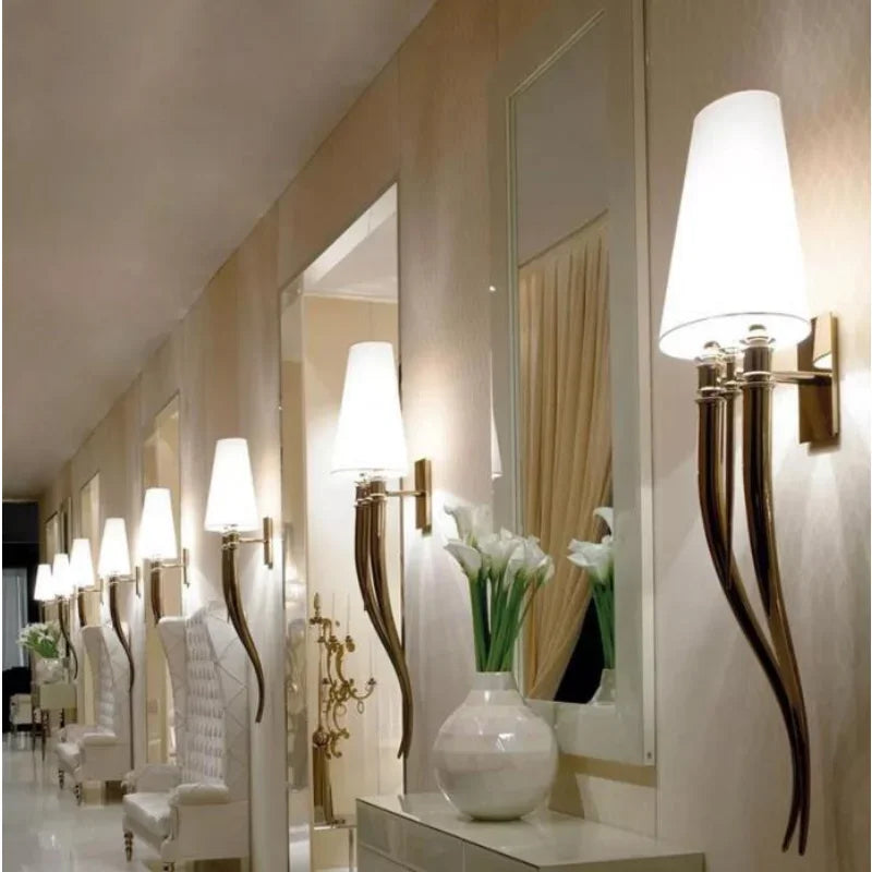 Decorative wall lights and mirrors in a stylish interior setting.