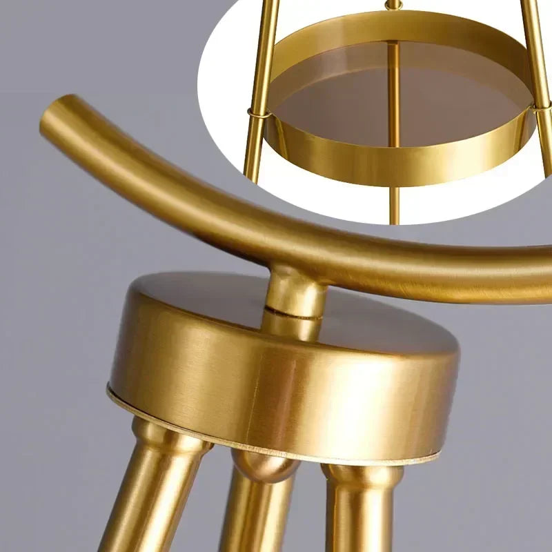 Gold metal stool with a gray background