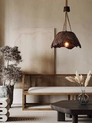 Modern interior with wooden bench, pendant light, and decorative elements.