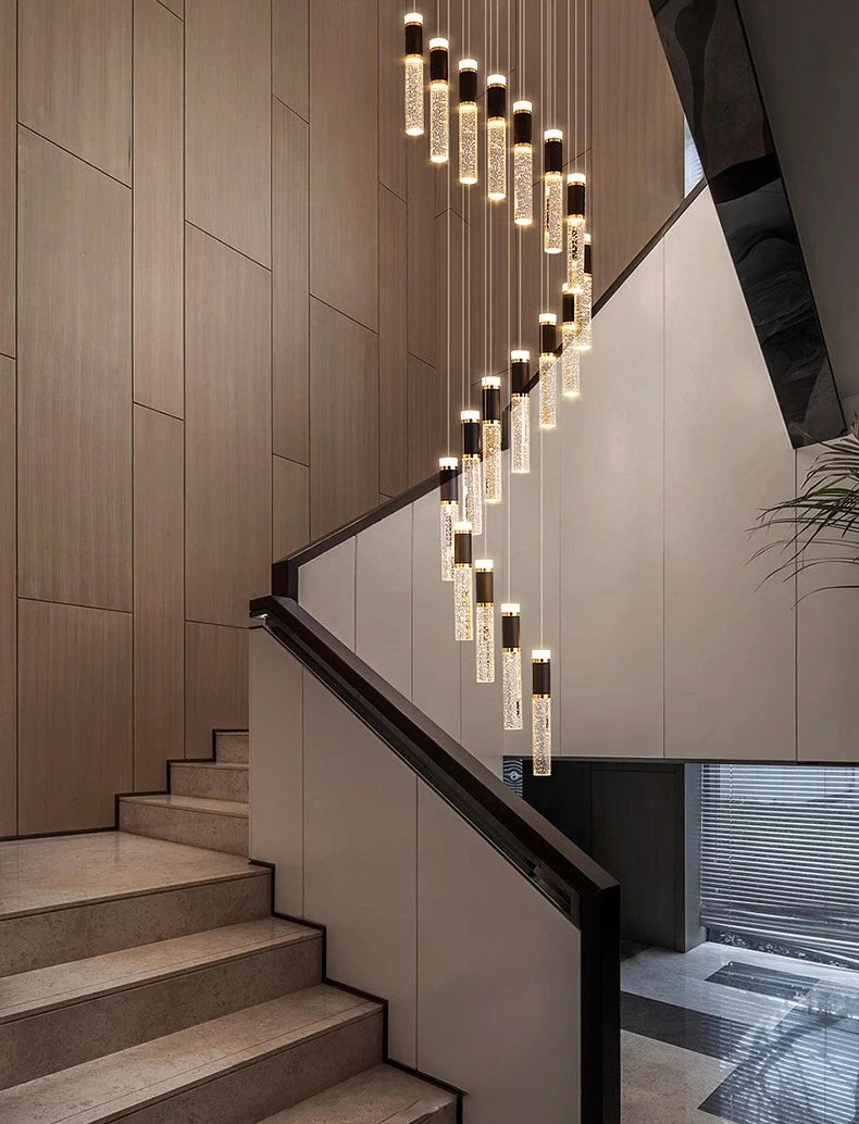 Modern staircase with a decorative chandelier in a stylish interior setting.