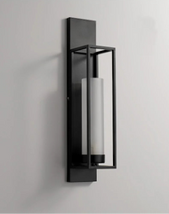 Modern wall-mounted light fixture with black frame and cylindrical glass shade on a gray background