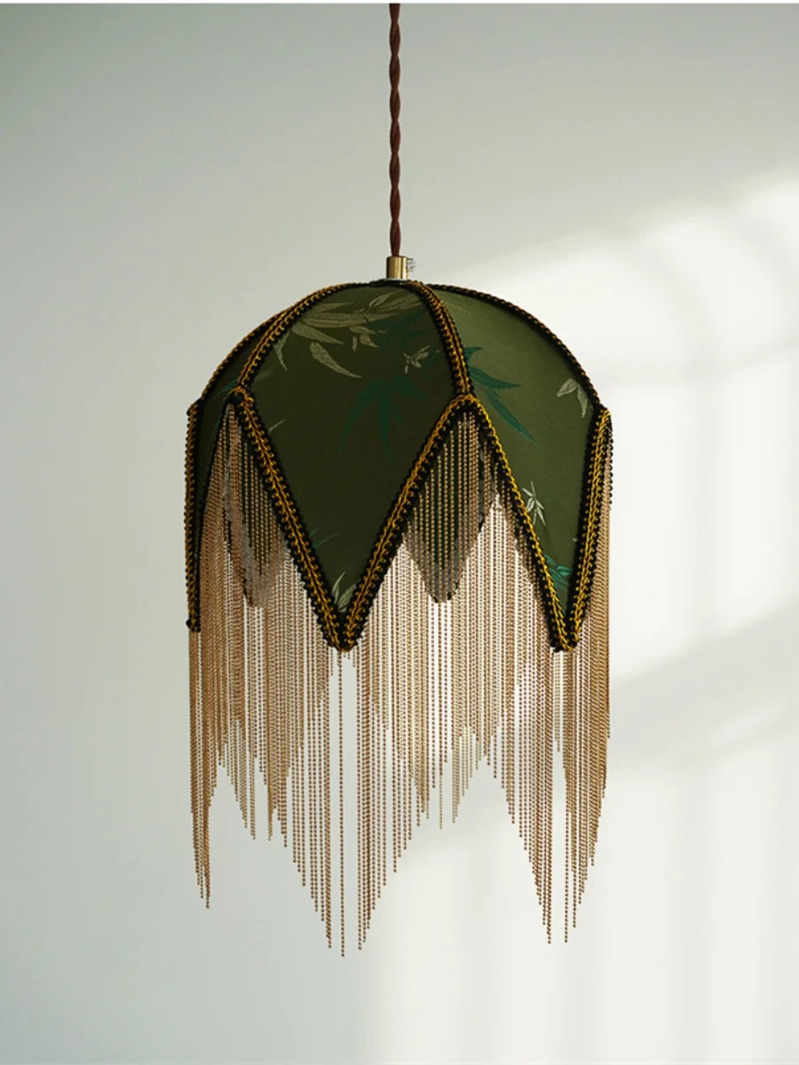 Decorative pendant light with green fabric shade and gold fringe