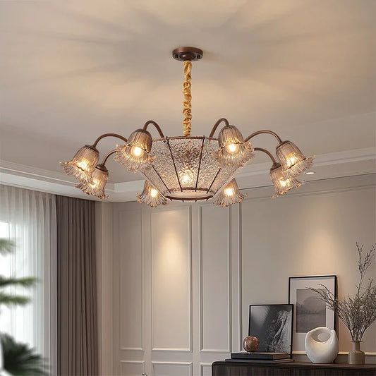 Bronze floral glass shade chandelier hanging from a ceiling.