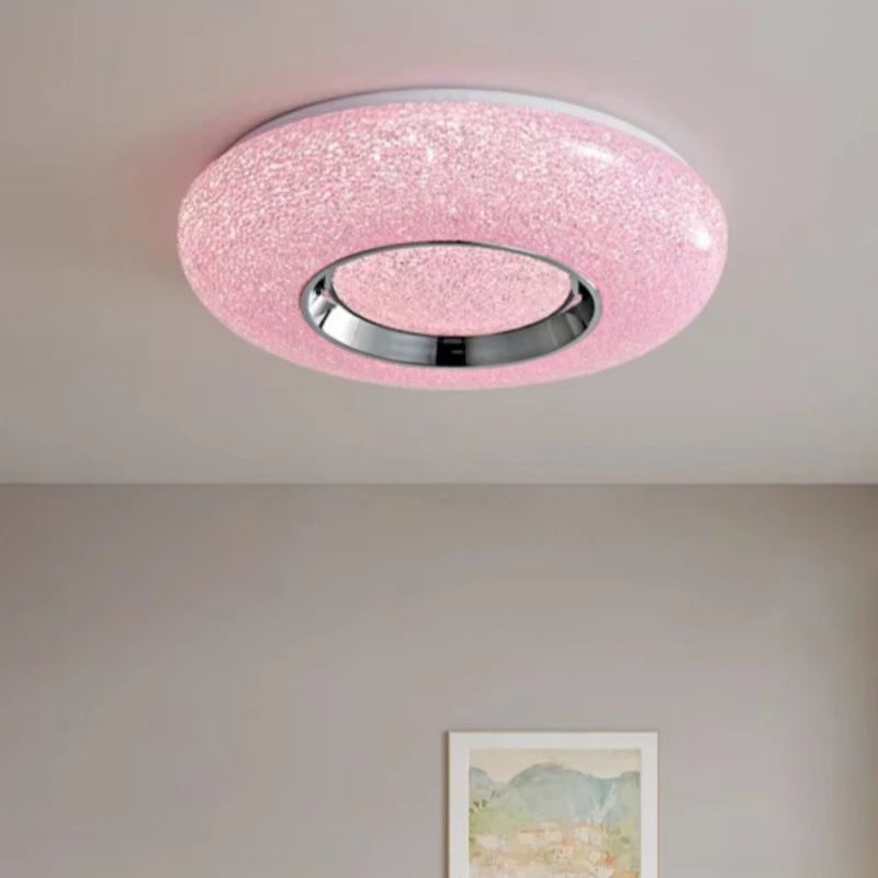 Circular flush mount ceiling light with a textured pink surround and a central chrome ring, studded with small sparkling lights.