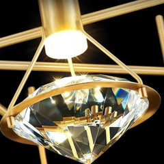 Gold chandelier with crystal-like shade against a black background