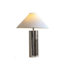 Table lamp with a white shade and chrome base on a white background