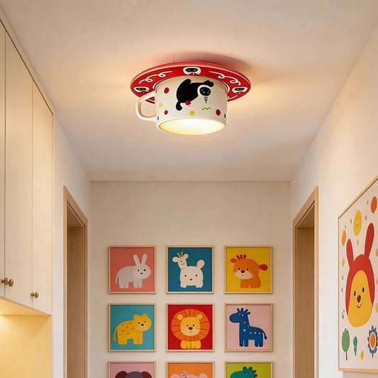 Ceramic coffee cup shaped ceiling light with a cat design mounted on a hallway ceiling