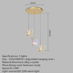 Gold pendant light with swan design and dimensions on a gray background