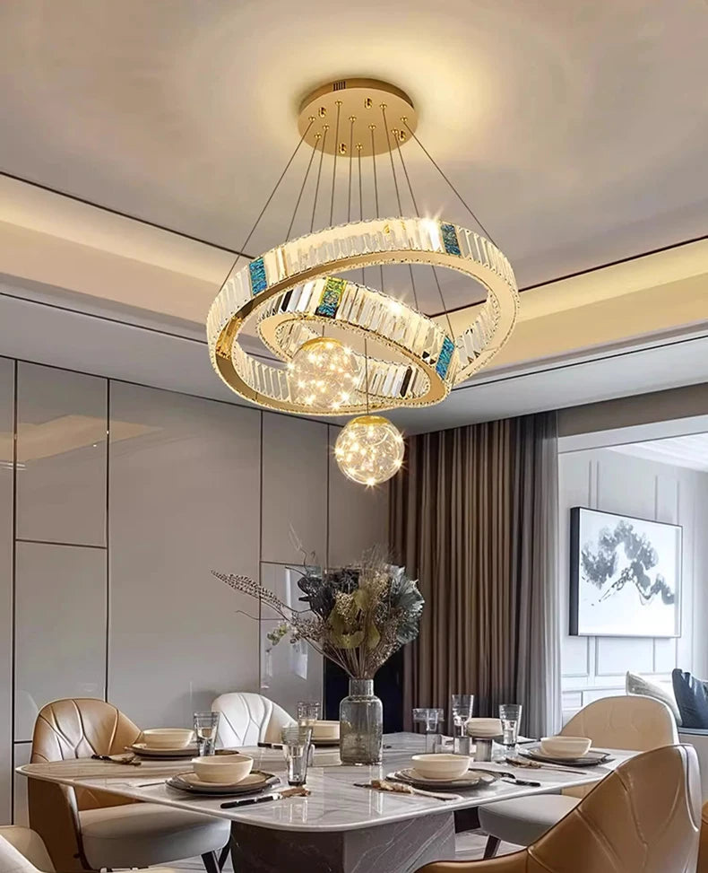 Modern chandelier hanging above a dining table in a stylish room.