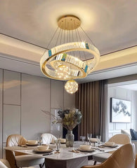 Modern chandelier hanging above a dining table in a stylish room.