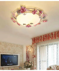 Pink rose bud floral design semi-flush ceiling light installed in a living room with floral wallpaper and striped curtains