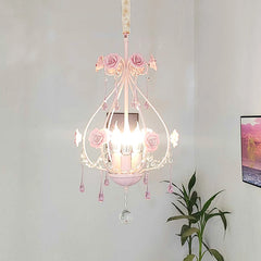Pink floral crystal pendant light installed in a room with a plant and framed art on the wall.