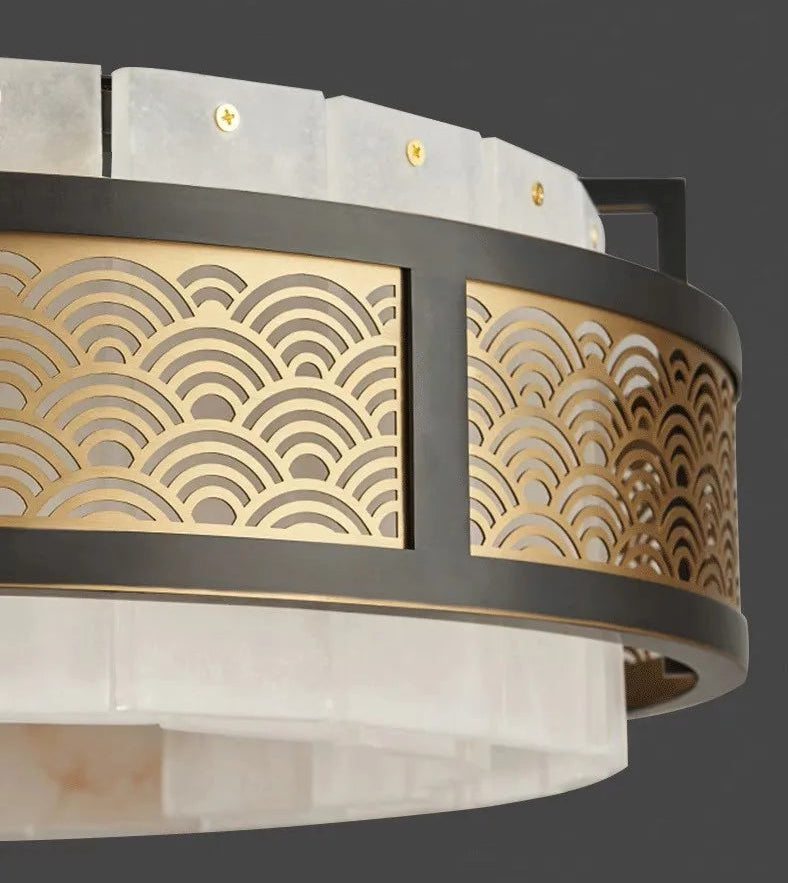 Decorative ceiling light fixture with gold wave patterns on a dark background