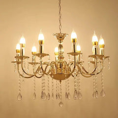 Close-up of the intricate gold metalwork and clear teardrop crystals on a waterfall chandelier.