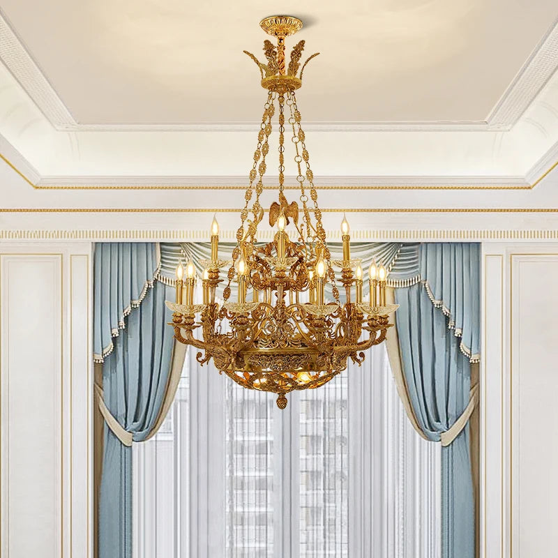 Gold candelabra crystal chandelier with blue curtains in the background.