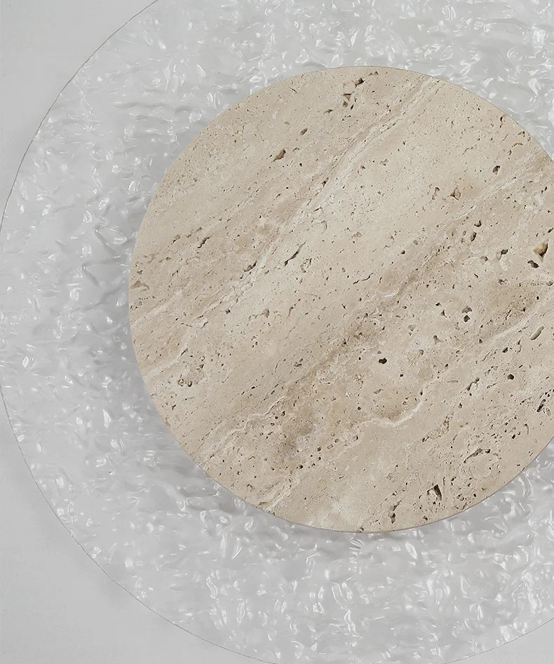 Round beige stone coaster on a clear glass surface