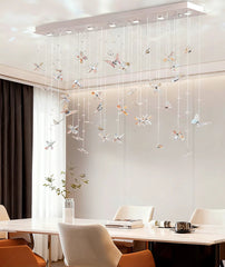 Modern chandelier with decorative elements in a dining room setting.